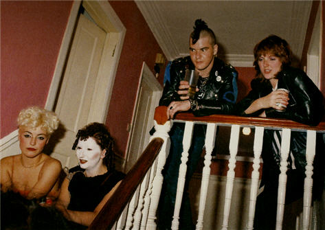 Jordan on the stairs while Darby Crah & Farah Fawcett Minor look on at a London party for X (Jenny Lens) 