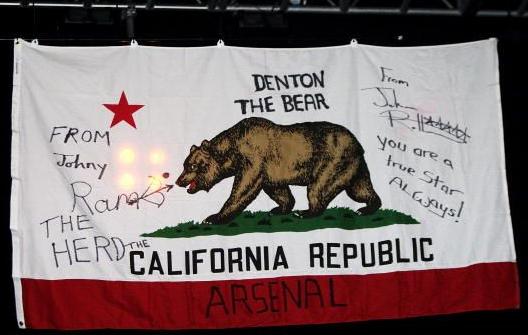 Johnny's Californian Republic flag draped on the backdrop and side of his Red London bus