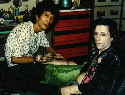 one of the last images of Johnny Thunders alive getting tattooed in bangkok by Jimmy Wong he was found dead a few weeks later 